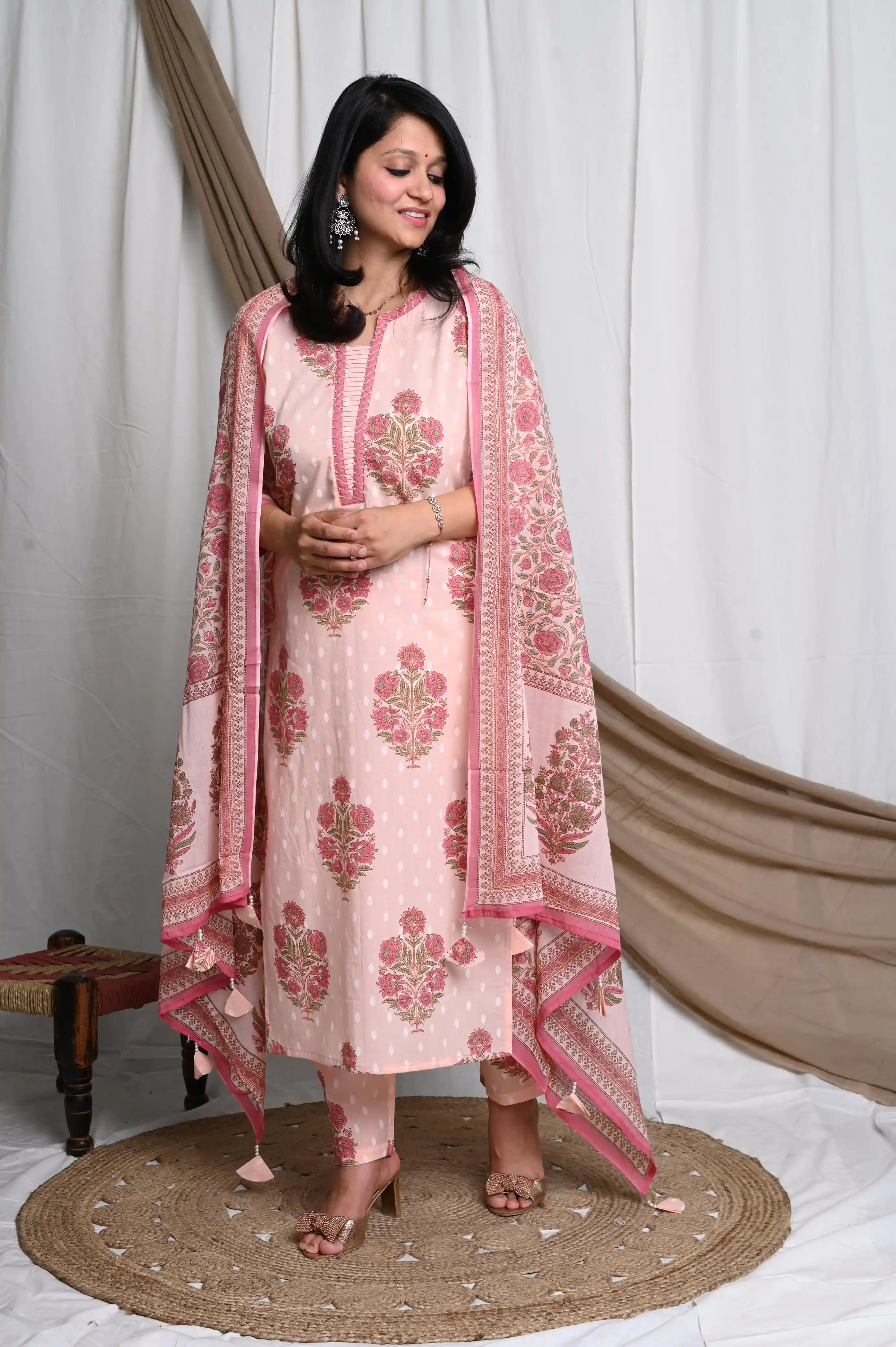 This hand block suit features a beautifully handcrafted yoke adorned with exquisite pearl detailing , accompanied by a soft mul cotton lining for maximum comfort. It also includes a meticulously hand-stitched dupatta, finished with delicate hand-tied tassels for a truly luxurious touch | Gown and Kurti | hand block suit